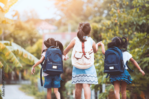 Back to school. Asian pupil kids with backpack going to school together in vintage color tone