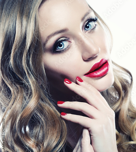 Beautiful woman face closeup with long blond hair and vivid red lipstick