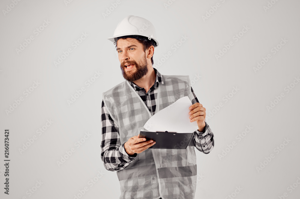 builder in a helmet on a light background builder in a helmet on a light background