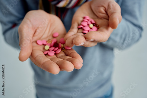 woman holding a handful of pills