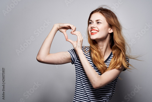 woman smiling hands heart