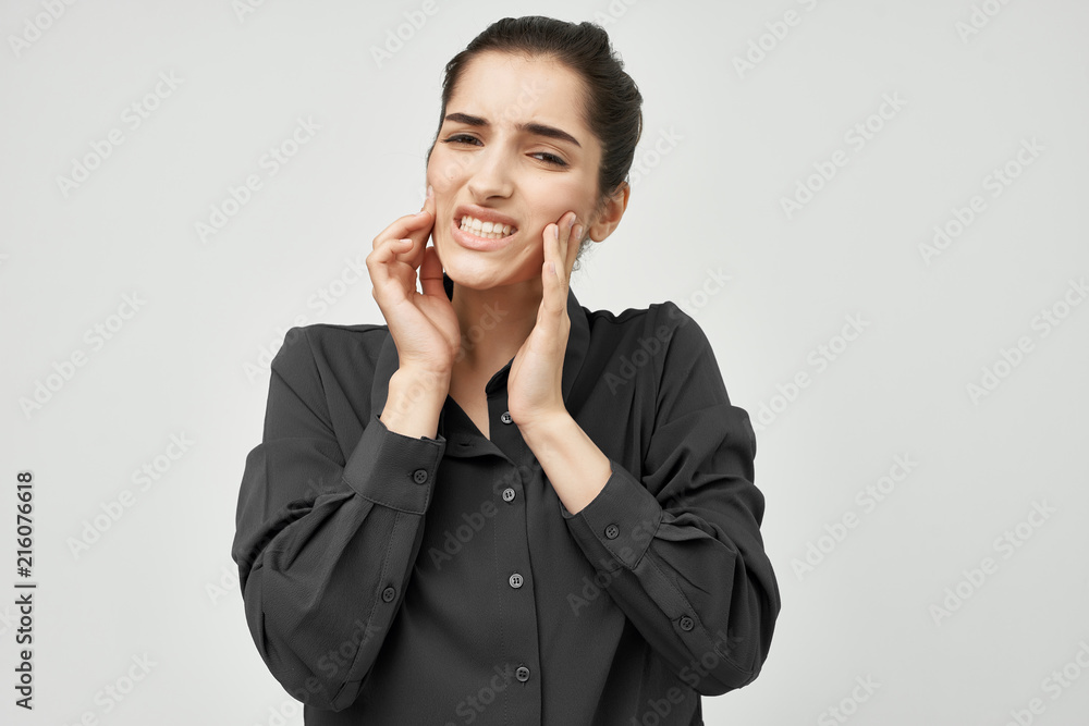 toothache, a woman touches her face with her hands, a black shirt toothache, a woman touches her face with her hands, a black shirt