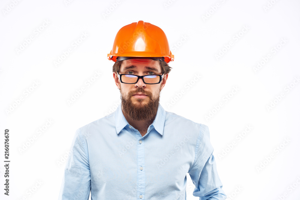 engineers in an orange helmet and wearing glasses, a light shirt engineers in an orange helmet and wearing glasses, a light shirt