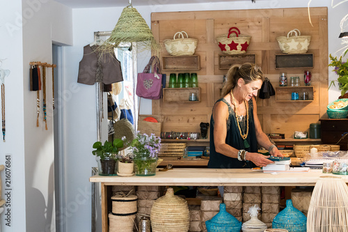 Portrait of a french blonde mature woman working at her store, entrepreneur concept.