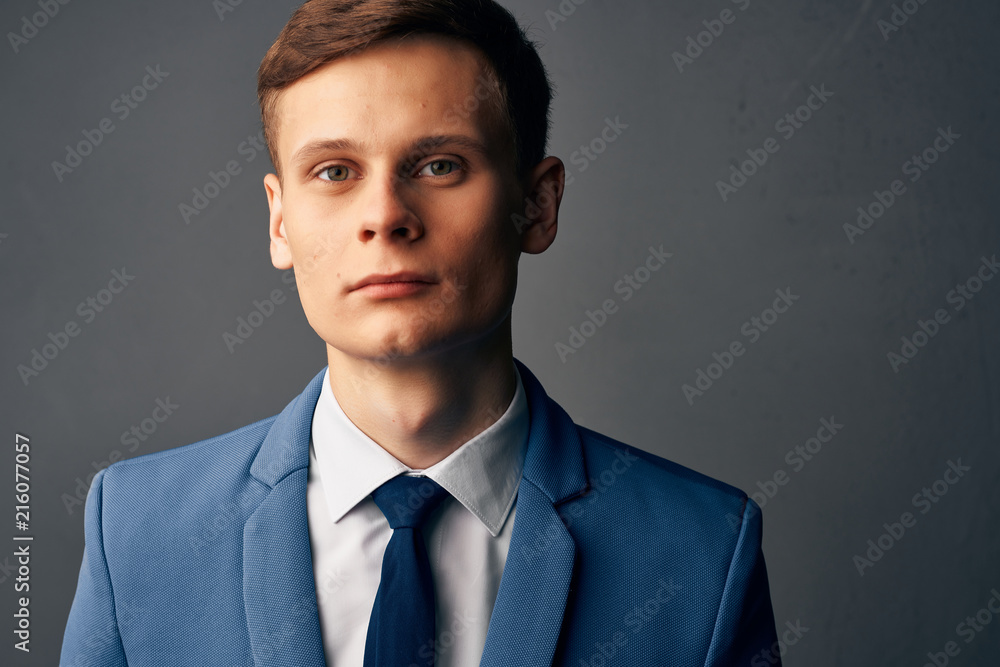 man in a classic suit against a gray background man in a classic suit against a gray background