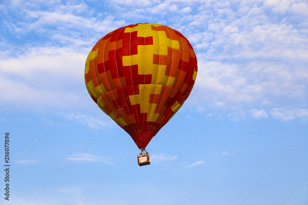 colorful hot air balloon against blue sky. hot air balloon is flying in white clouds. beautiful flying on hot air balloon colorful hot air balloon against blue sky. hot air balloon is flying in white clouds. beautiful flying on hot air balloon