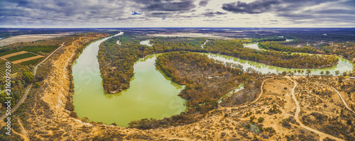 Aerial panorama of Murray River flowing into the horizon among gum trees in Murtho, South Australia