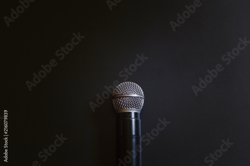 Microphone on the book with black background. Call center service operator empty working place.