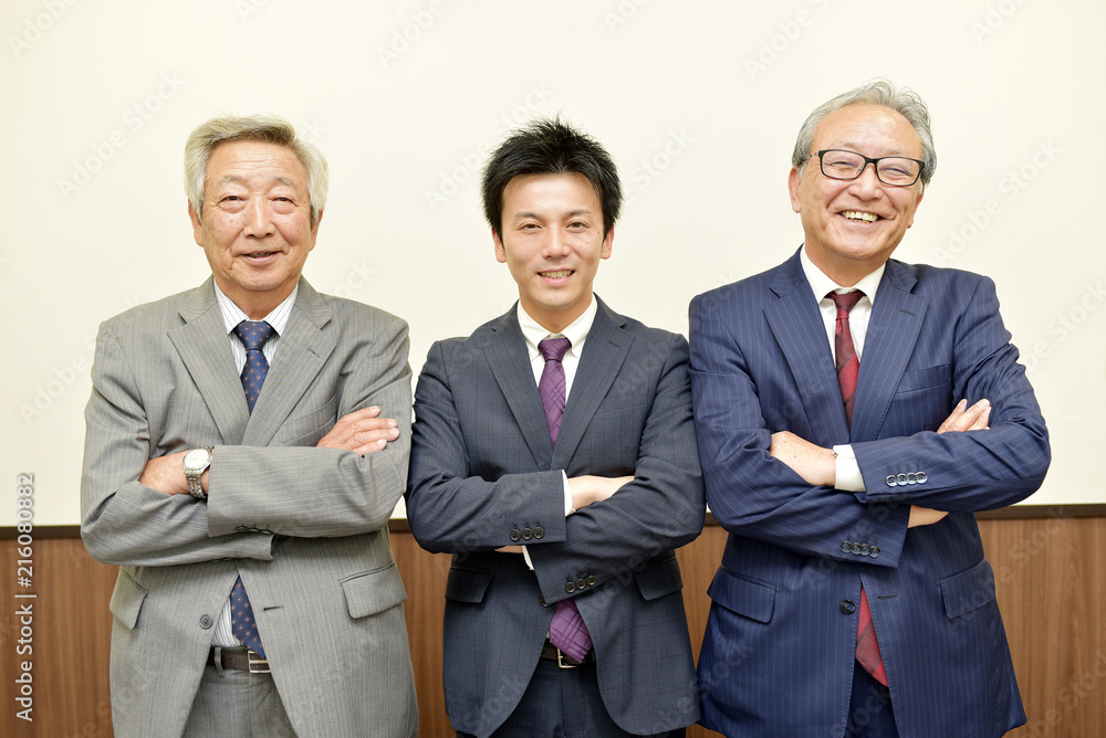 腕組みをする若手ビジネスマンと重役 腕組みをする若手ビジネスマンと重役