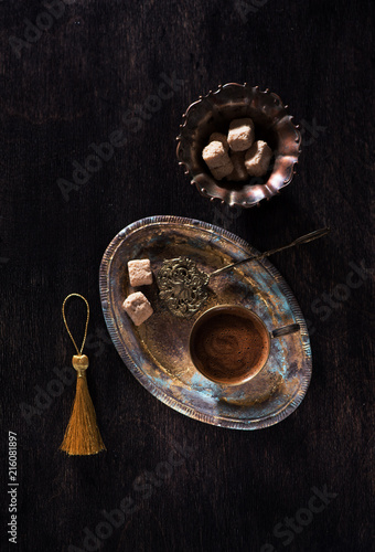 Retro still life with cup coffee and sugar on antique tray, top view