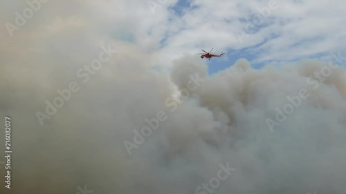 During the wildfires in Attica Greece. View of the smoke from the highway and Skycrane helicopter firefighting.