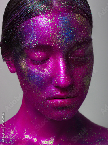Woman space. A creative make-up of the person by means of bright paints and the poured pigments. Halloween, holidays, studio of beauty and art
