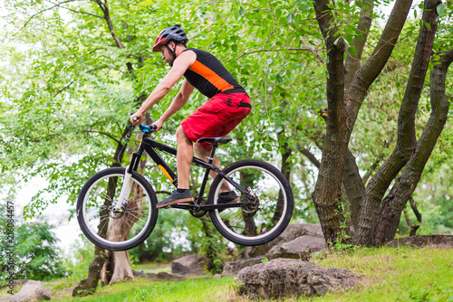Extreme cycling, a cyclist jumping on a mountain bike. © mihakonceptcorn