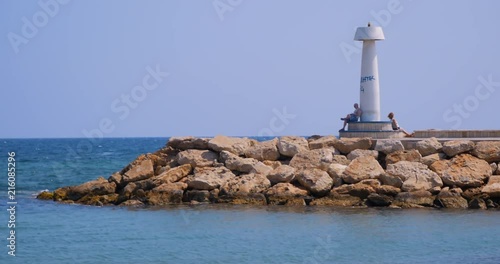 lighthouse in Zyprus (Zypern) sunbathing people photo