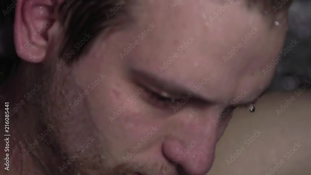 Depressed young man taking a shower and thinking about life. Super slowmotion footage. Depressed young man taking a shower and thinking about life. Super slowmotion footage.