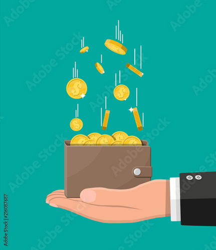 Falling gold coins and leather wallet in hand