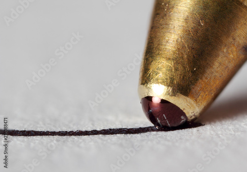 Extreme macro photo of pen writing to paper.