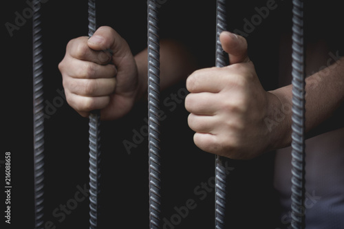 Foto The man was imprisoned in a steel cage, prisoner concept, Hope to be free