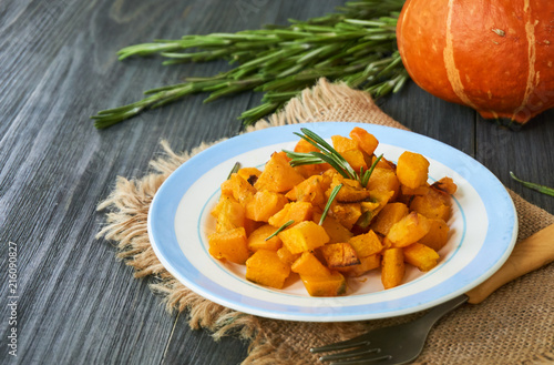 Baked pumpkin with rosemary on a plate