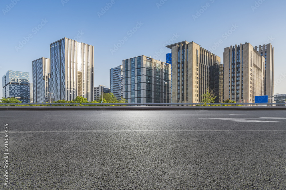 Panoramic skyline and modern business office buildings with empty road,empty concrete square floor Panoramic skyline and modern business office buildings with empty road,empty concrete square floor
