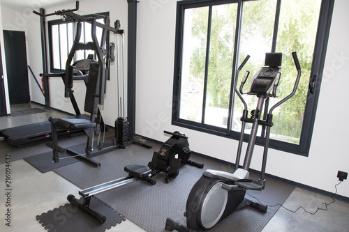 Modern Gym Room Fitness Center interior with equipment And Machines