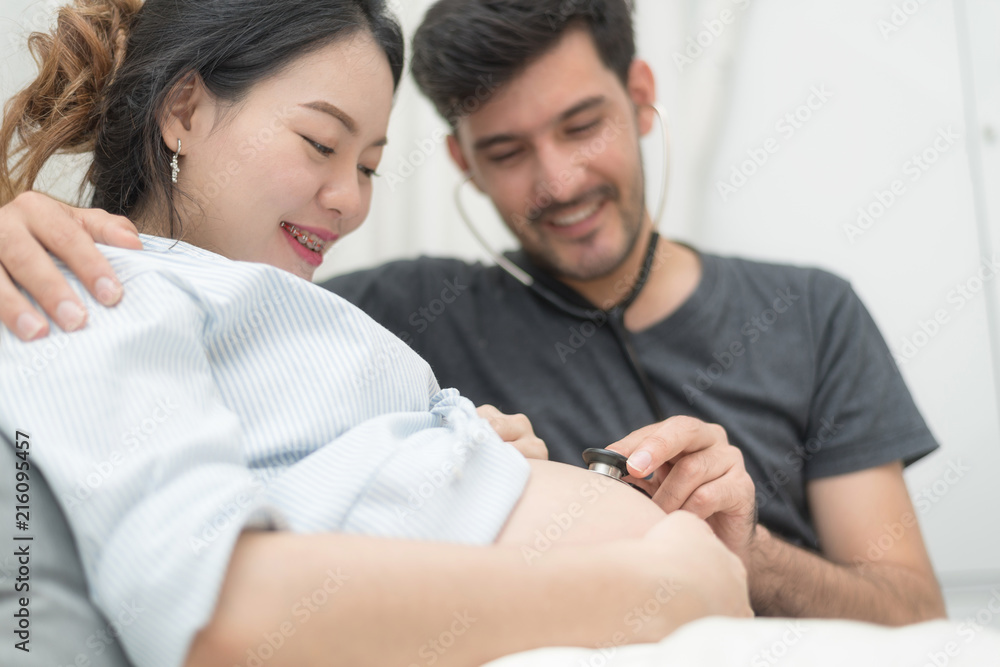 In Selective Focus Of Happy Family Checking New Baby In The Morning.Close Up Of A Beautiful Happy Pregnant Woman With Big Belly. Pregnancy And Motherhood Moment People And Expectation Concept. In Selective Focus Of Happy Family Checking New Baby In The Morning.Close Up Of A Beautiful Happy Pregnant Woman With Big Belly. Pregnancy And Motherhood Moment People And Expectation Concept.