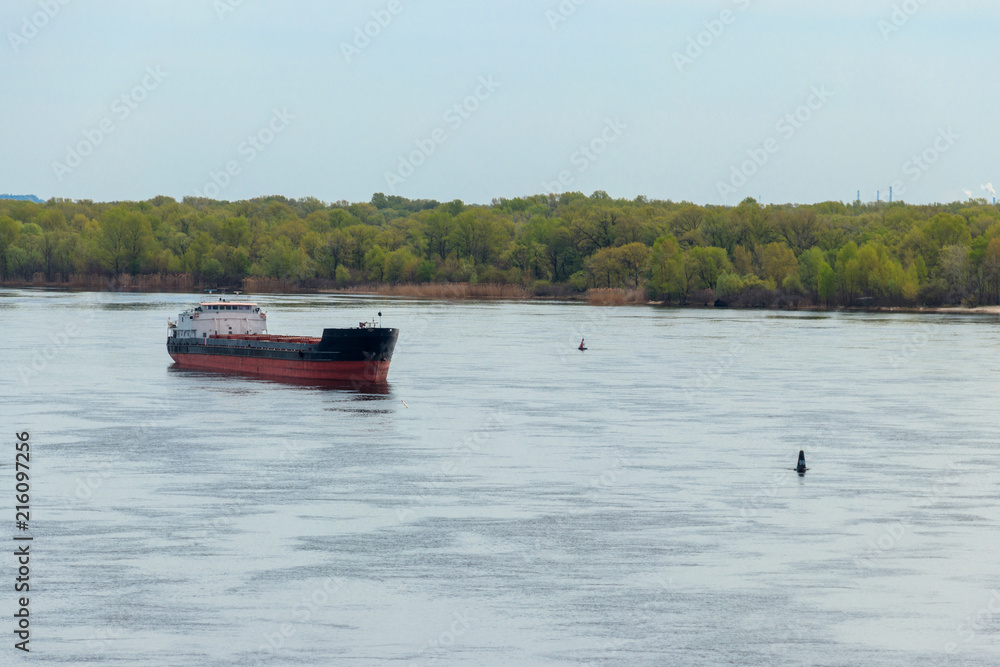 Obraz premium Cargo ship sailing on the river Dnieper