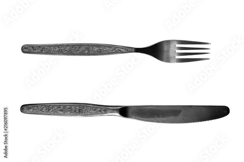 Metallic fork and knife of silvery color on a white background.