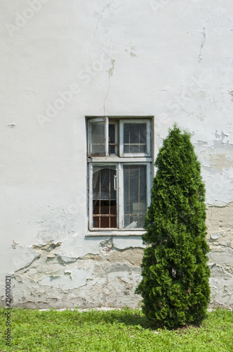 A wall of an old building with a window.