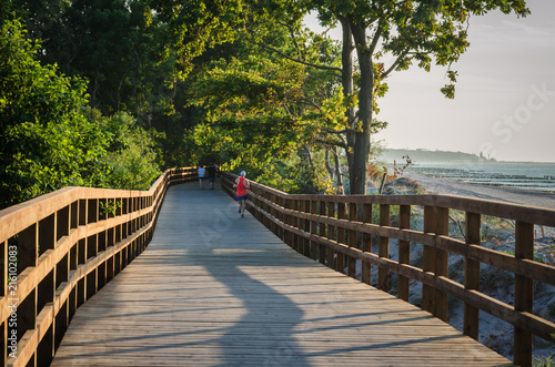 Fotografija JOGGING - Evening sports activity on the sea shore near Kolobrzeg