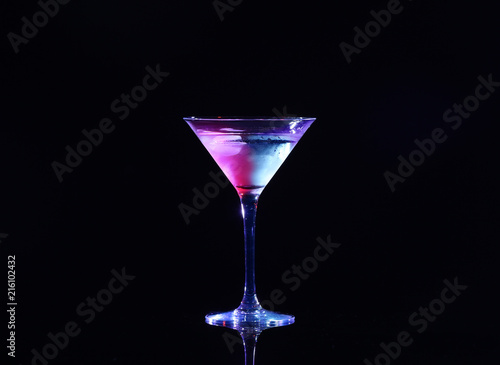 Glass with cocktail on black background