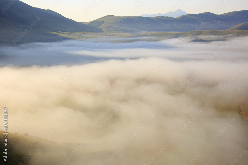 Flying on Castelluccio di Norcia, between ruins and bloom of flowers Flying on Castelluccio di Norcia, between ruins and bloom of flowers