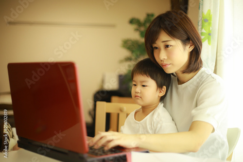 パソコンを使う親子 © yamasan