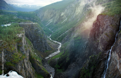 Waterfalls flowing from a high rock into a deep cleft in Norway © morelena