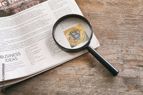 Magnifying glass and newspa...