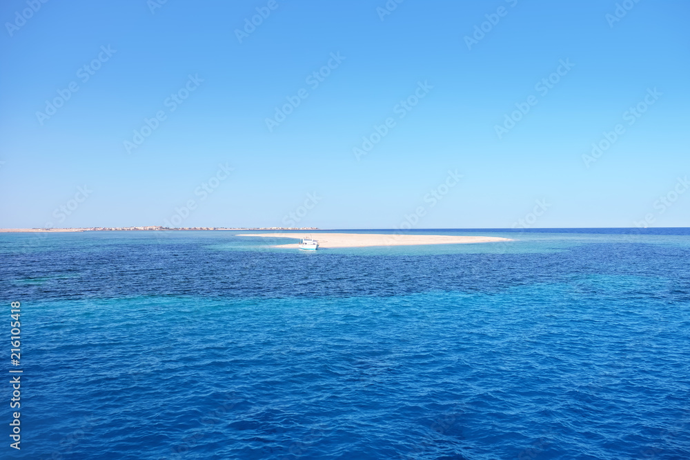 View of beautiful seascape with small island on summer day