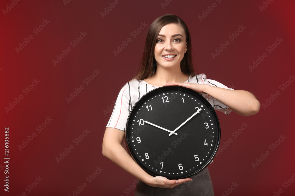 Woman with clock on color background. Time management concept Woman with clock on color background. Time management concept