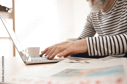 Senior man reading news on ...