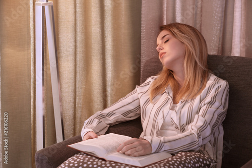 Young woman sleeping in arm...