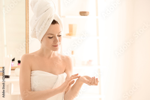 Beautiful woman applying cr...