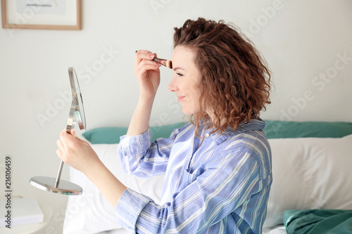 Beautiful woman applying ma...