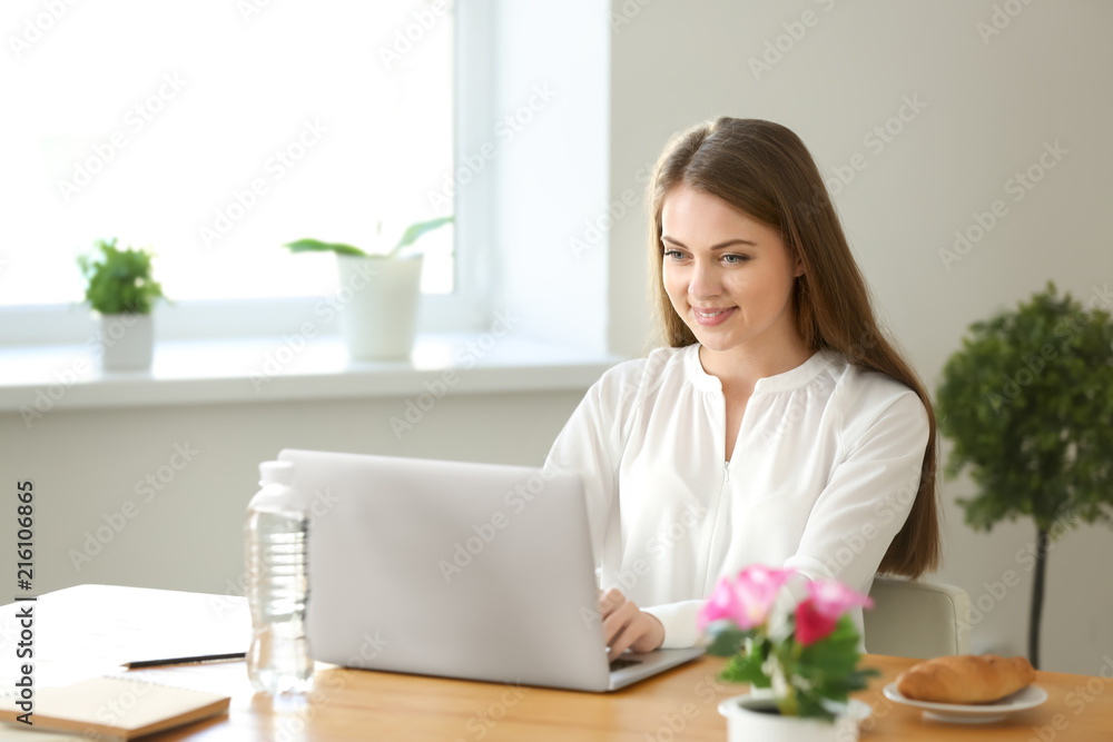 Female freelancer working on laptop in home office Female freelancer working on laptop in home office