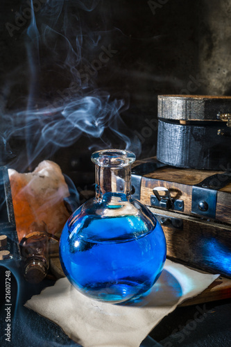 Obraz na płótnie Magic concept. Blue potion in glass bottle w salonie