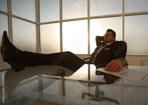 successful businessman relaxing at the table