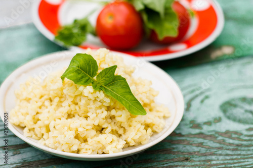 Cooked Bulgur Rice with Quinoa in Plate Ready to Eat. / Bulghur for Pilav or Pilaf photo