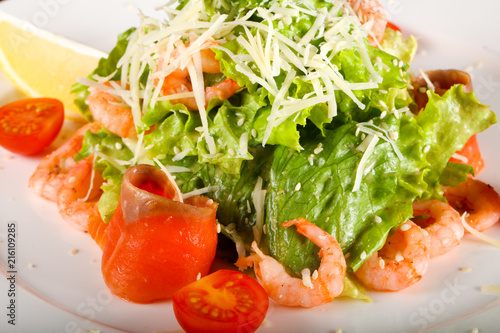 Caesar salad with shrimps and salmon