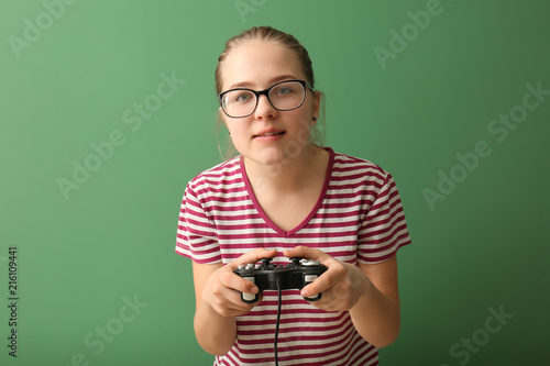 Cute girl with gamepad on c...
