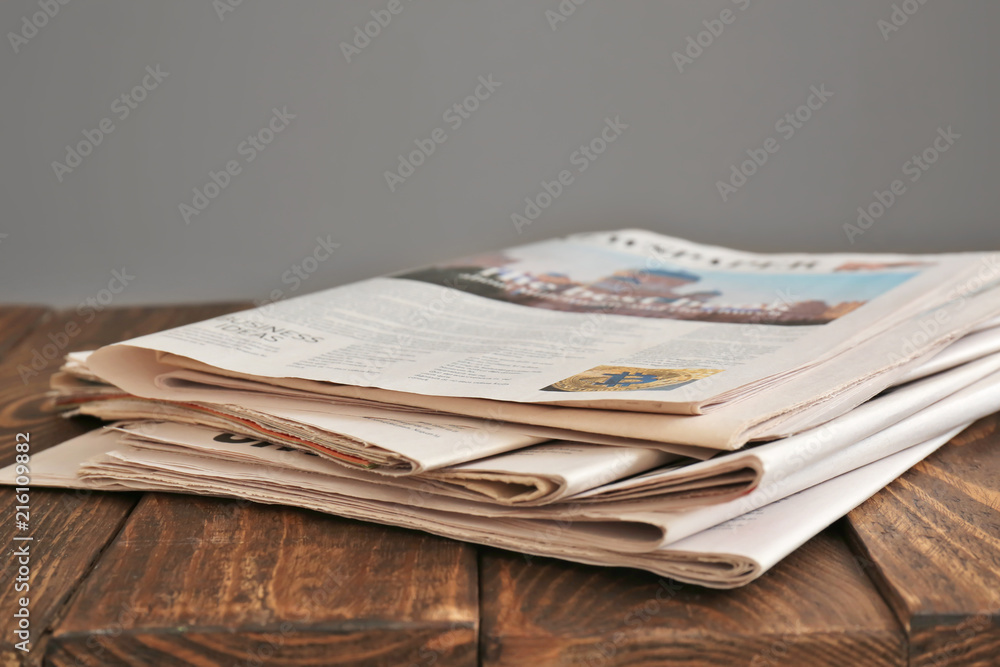 Pile of newspapers on wooden table Pile of newspapers on wooden table