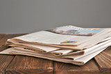 Pile of newspapers on wooden table