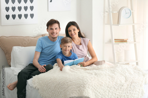 Happy family reading book t...